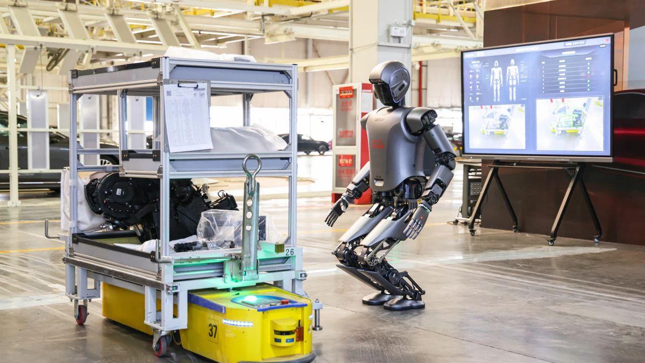 A robot standing in a warehouse bending down to pick up items from a metal shelf.