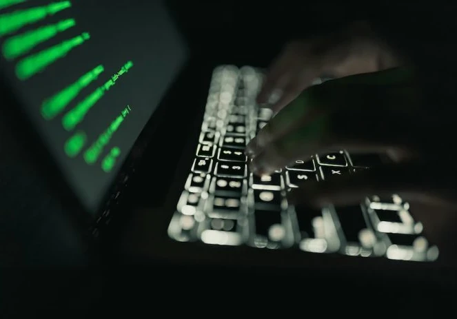 Hacker working on a laptop showing a data leak