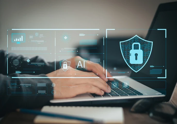 A businessman typing on a laptop with icons floating around it depicting online security.