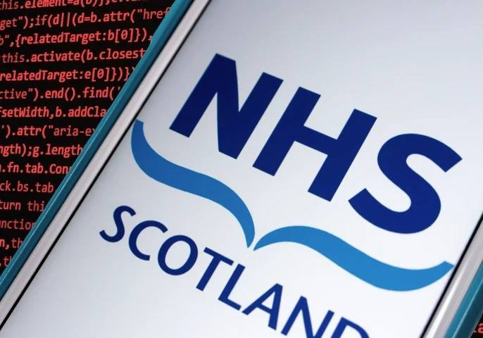 NHS Scotland logo on a smartphone with a coding background.