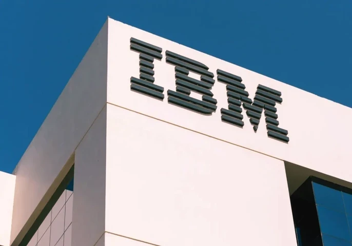 IBM logo on a white building with a blue sky above.