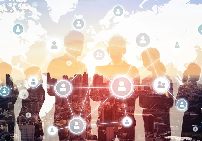 Silhouettes of businesspeople against a city backdrop with icons and profiles overlaid on top.