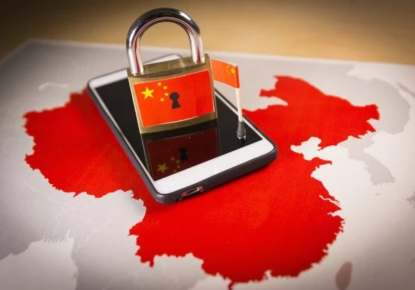 Smartphone on map of China, along with a padlock with the China flag on it