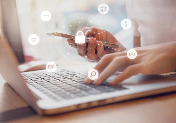person working on a smartphone and laptop