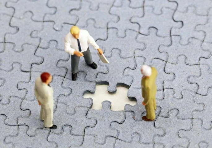 Three figurines surrounding a missing puzzle piece.