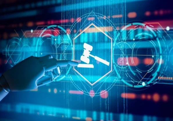 Robotic hand pointing to a gavel on a blue screen.