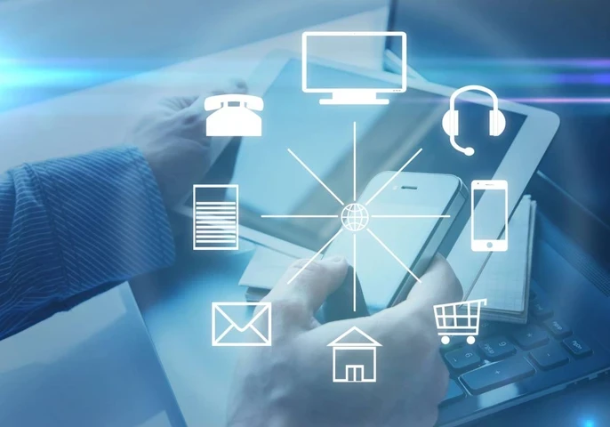 Communication icons overlaid on top of a person using a smartphone, tablet and laptop.