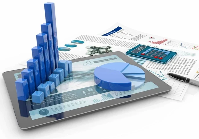 A smartphone and calculator lying on top of a desk with animated depictions of graphs.