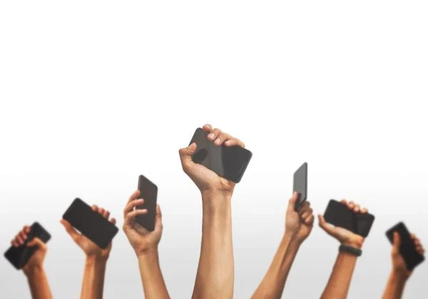 Hands holding up smartphones