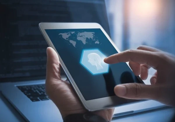 person using a tablet featuring a person sketch showing artificial intelligence