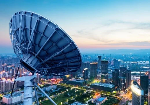 satellite over a city at dusk
