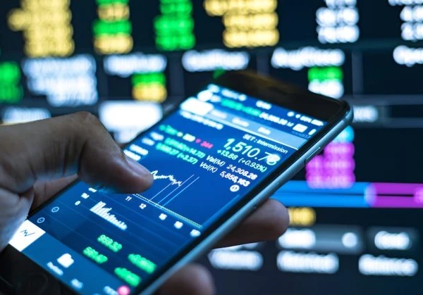 Person using a smartphone to check market prices and stocks