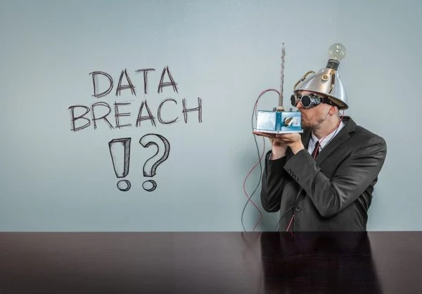 Conspiracy theorist standing in front of a board that reads 'data breach?!'