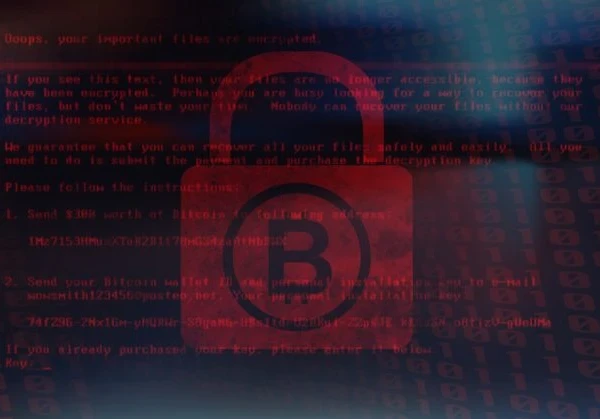 bitcoin logo on a padlock behind lines of code in red