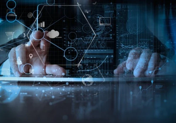 Person typing on a keyboard with a touchscreen in front of them with data points that they're tapping