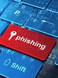 A keyboard with one of the keys showing the word "phishing" and a key icon.