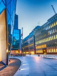 A view of a UK business district at dusk.