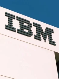 IBM logo on a white building with a blue sky above.