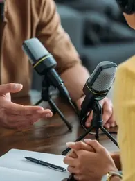 Two people recording a podcast