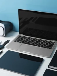 Photo of various digital devices including laptop, tablet, smart watch, VR goggles and more