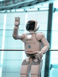 A humanoid robot by Honda being showcased at an event.