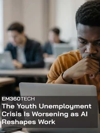 EM360Tech news graphic showing a young man looking thoughtfully at a laptop in a shared workspace, with other people working on laptops in the blurred background. Text reads: “The Youth Unemployment Crisis Is Worsening as AI Reshapes Work.” 