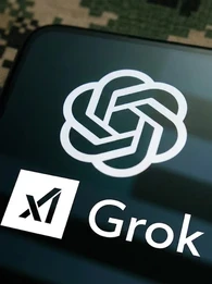 A smartphone against a camouflage background with the screen displaying the OpenAI and Grok logos.