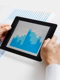 person holding a tablet with a graph