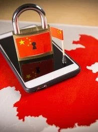 Smartphone on map of China, along with a padlock with the China flag on it