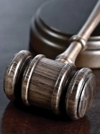 Close-up of a gavel on a wooden table