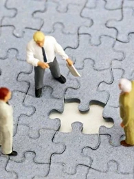 Three figurines surrounding a missing puzzle piece.