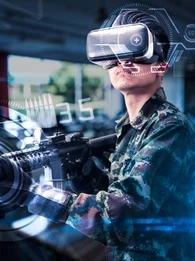 A person holding an imitation gun while using virtual reality goggles.