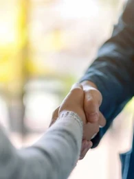 Two people shaking hands.