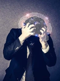 A business person in a suite holding his head in anguish