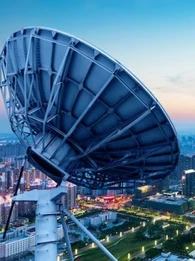 satellite over a city at dusk