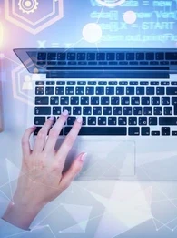 Person sitting at a desk and typing on a keyboard.