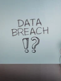 Conspiracy theorist standing in front of a board that reads 'data breach?!'