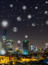 Technology icons overlaid on a city skyline at night.