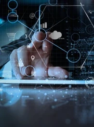 Person typing on a keyboard with a touchscreen in front of them with data points that they're tapping