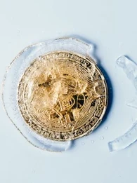bitcoin coin in gold frozen in ice
