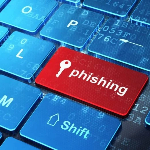 A keyboard with one of the keys showing the word "phishing" and a key icon.