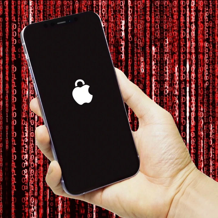 Person holding an iPhone up against a red background with binary code.