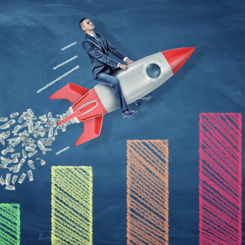 Man riding on a rocket on top of a graph.