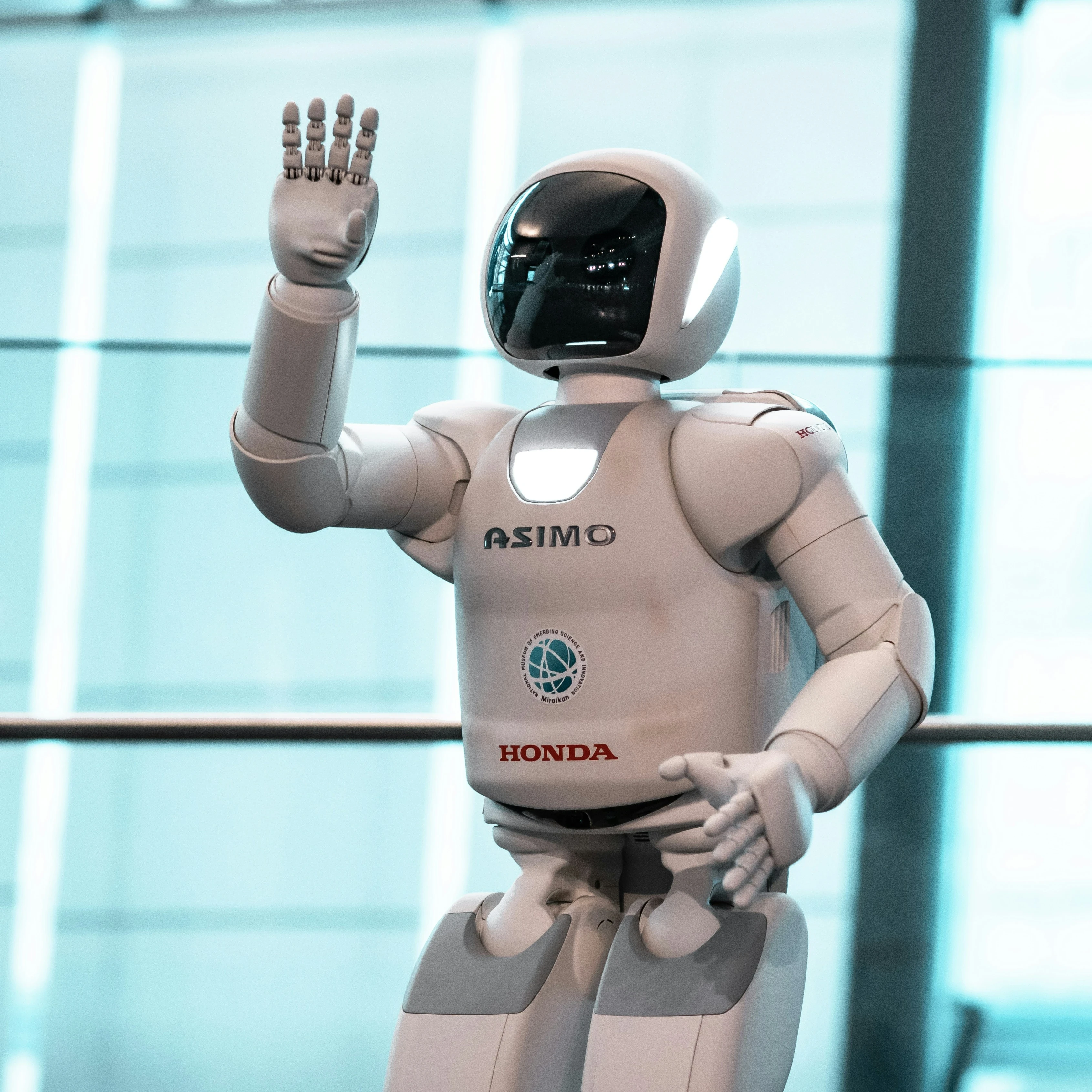 A humanoid robot by Honda being showcased at an event.