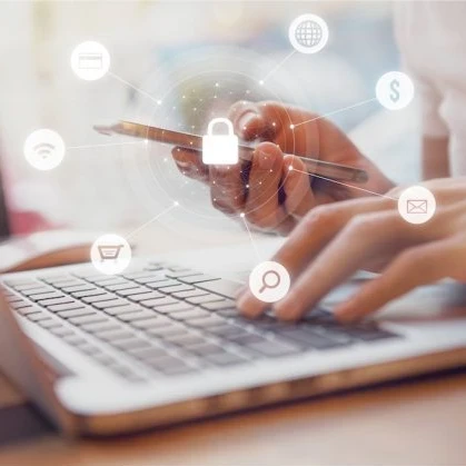 person working on a smartphone and laptop