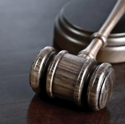 Close-up of a gavel on a wooden table