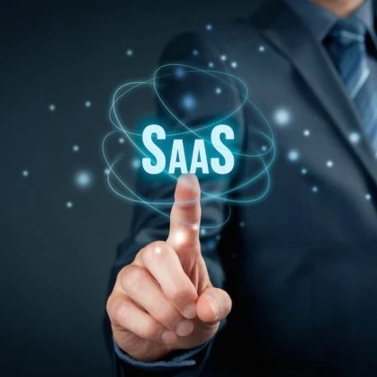 Person pointing to a sign that reads SaaS