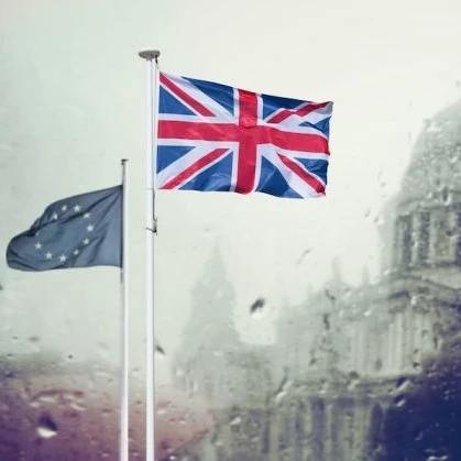 EU and Union Jack flags flying in front of St Paul's Cathedral in the rain