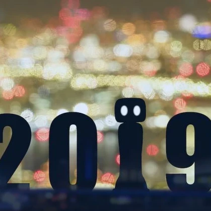 The year 2019 shown in front of a glowing cityscape with the 1 being represented by a robot