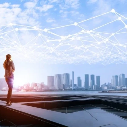 Person looking out across a river to a city skyline